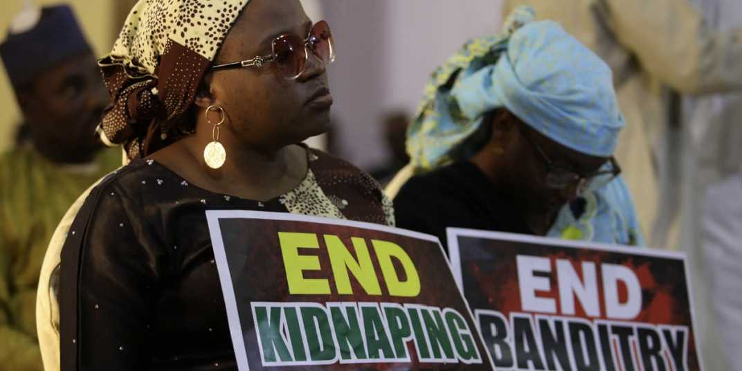 A demonstrator holds a sign during a protest to urge authorities to rescue abducted schoolboys in northwestern state of Katsina, Nigeria, 17 December 2020.